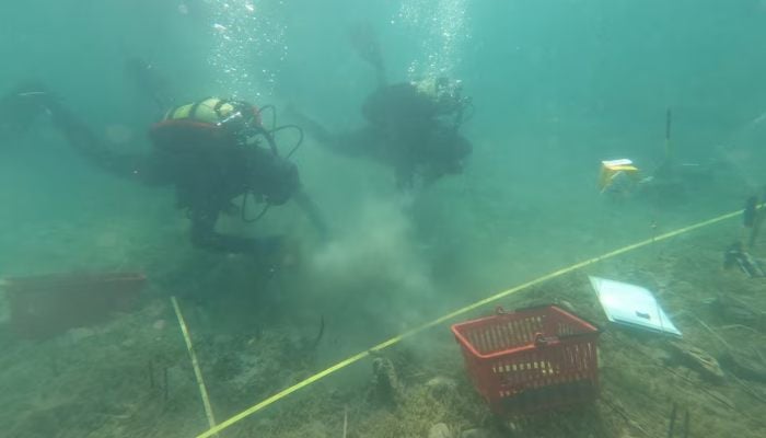 Archaeologists dive in the lake of Ohrid to uncover objects, in the village of Lin, Albania, July 11, 2025. — Reuters