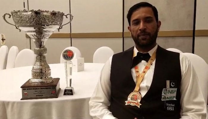 Pakistan’s ace cueist Mohammad Asif struck pictured with IBSF trophy. — Reporter