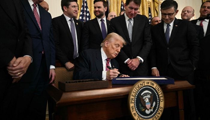 US President Donald Trump signs the GENIUS Act in the East Room of the White House in Washington, DC, on July 18, 2025. — AFP